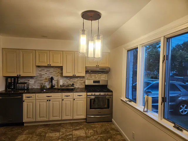 a kitchen with a stove a sink and a refrigerator