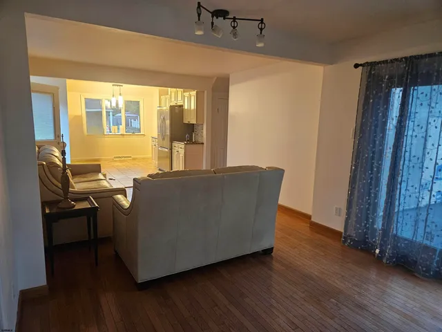 a living room with furniture and large window