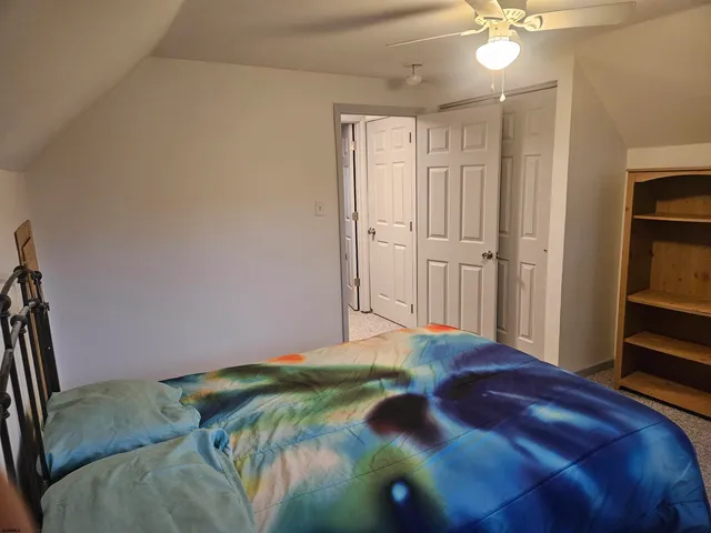 a bedroom with a bed table and a window