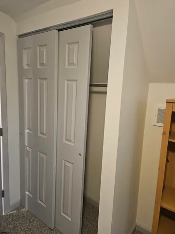 an empty room with windows and sink