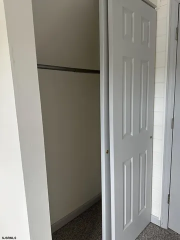 an empty room with a fan & a ceiling fan