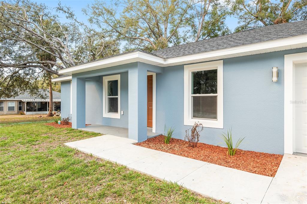15369 Southwest 38th Place Ocala, FL 34481 - Photo 1 of 1 a front view of a house with a yard