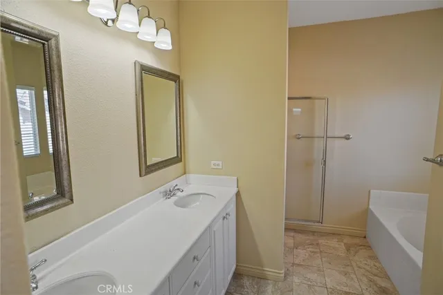 a bathroom with a double vanity sink mirror and shower