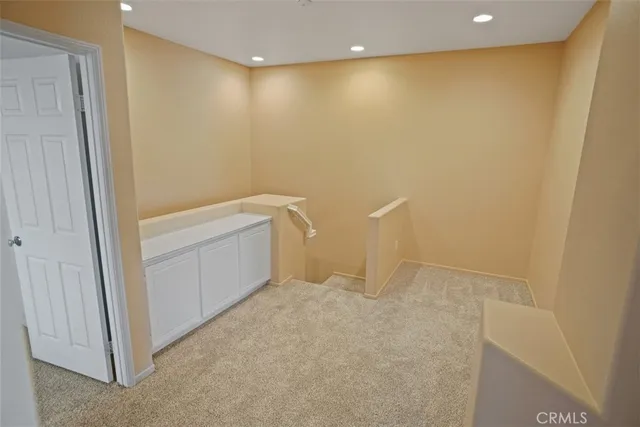 a bedroom with a bed and dresser with mirror