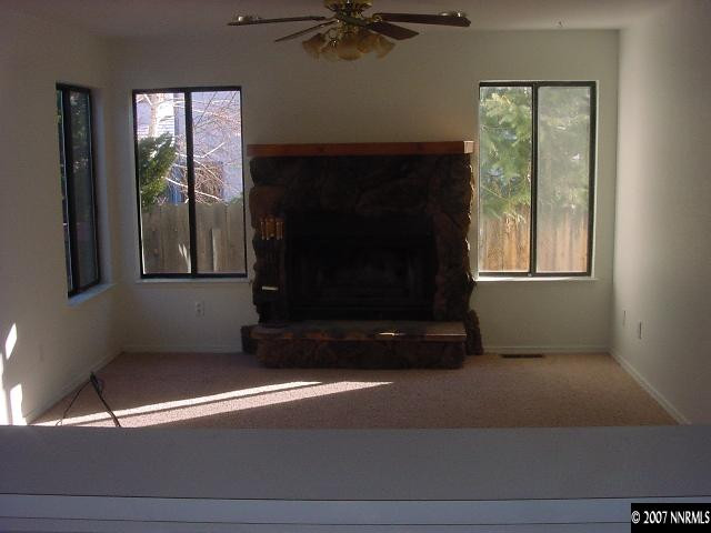 583 Citadel Road Reno, NV 89503 - Photo 3 of 7 a living room with a fireplace and a window
