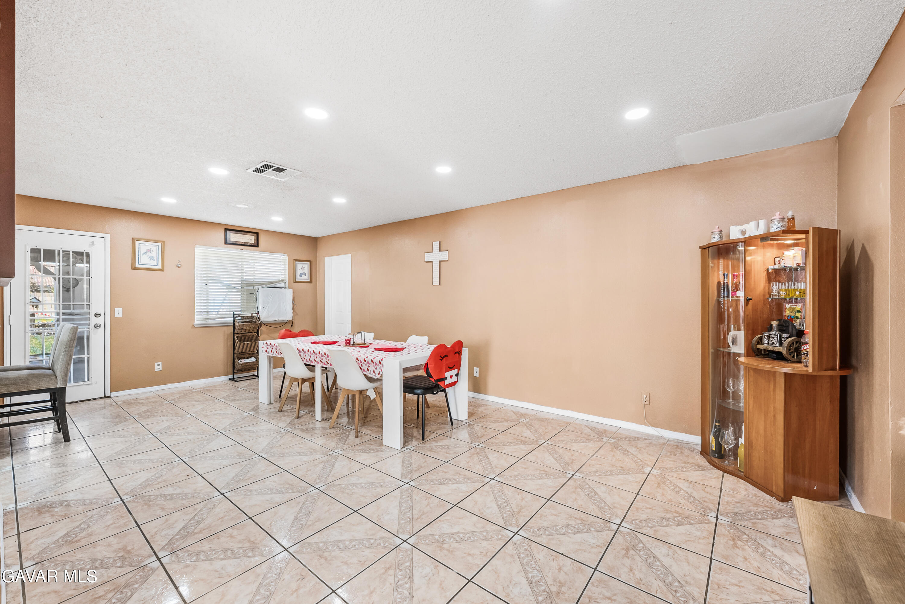 43903 11th Street East Lancaster, CA 93535 - Photo 15 of 45 a dining room with furniture and a kitchen view