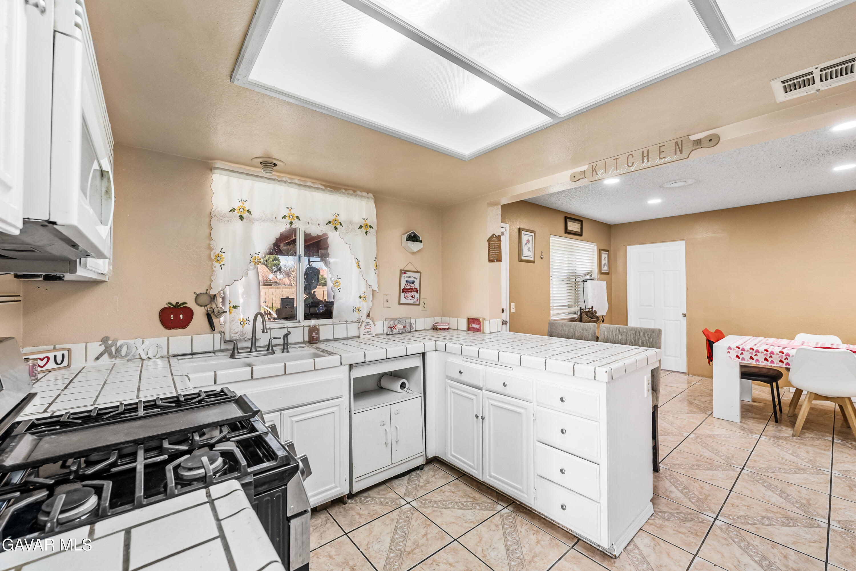 43903 11th Street East Lancaster, CA 93535 - Photo 24 of 45 a kitchen with a stove and white cabinets