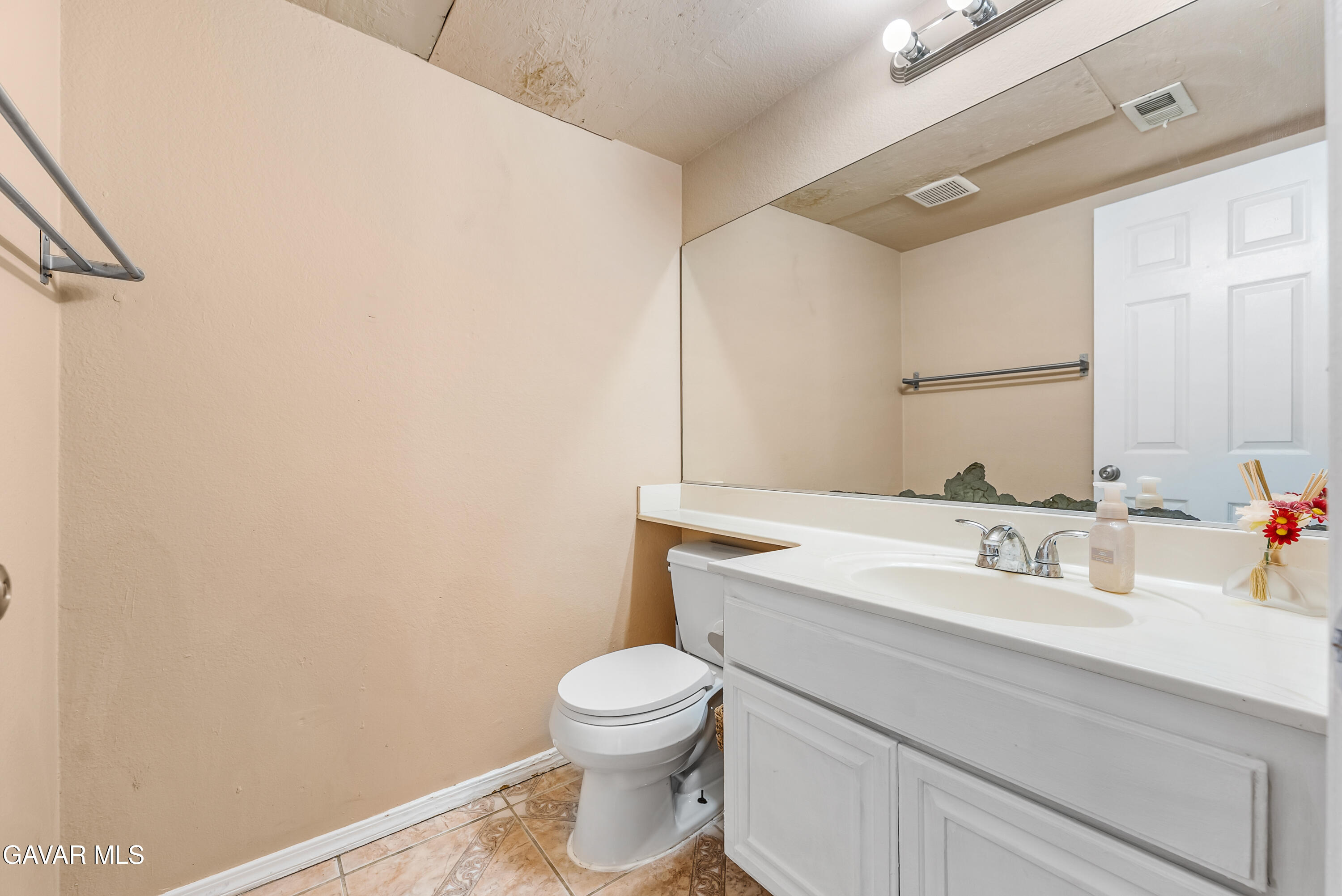 43903 11th Street East Lancaster, CA 93535 - Photo 28 of 45 a bathroom with a sink a toilet and mirror