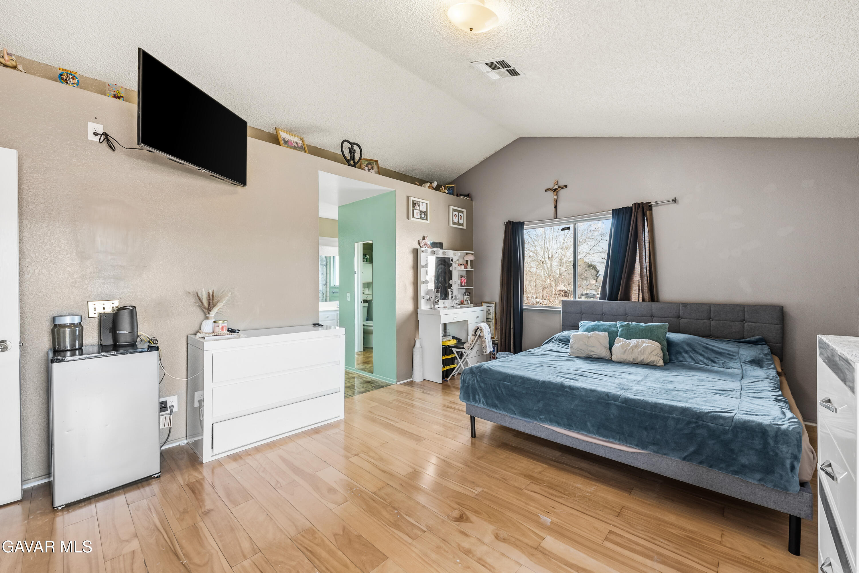 43903 11th Street East Lancaster, CA 93535 - Photo 31 of 45 a bedroom with a bed and a flat screen tv