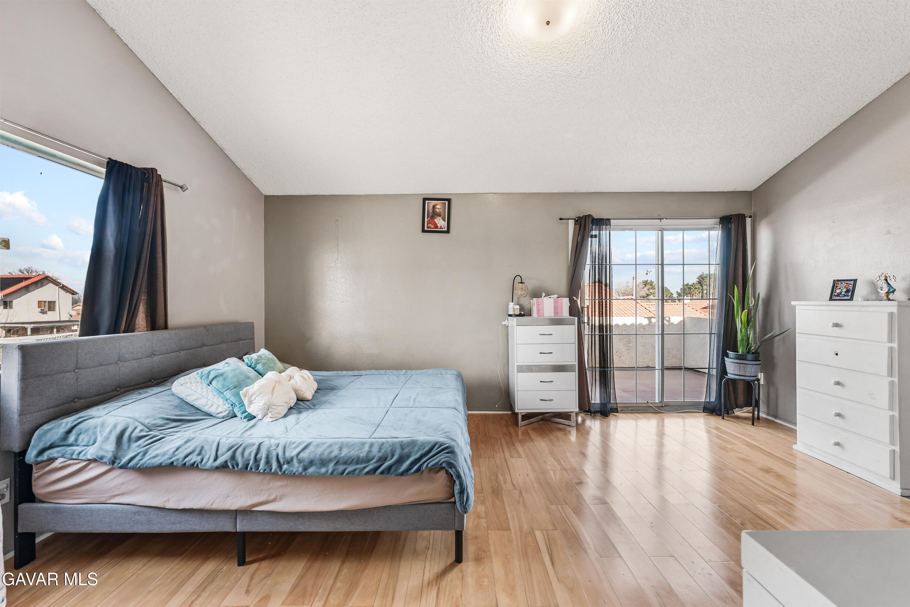 43903 11th Street East Lancaster, CA 93535 - Photo 32 of 45 a bedroom with a bed and wooden floor