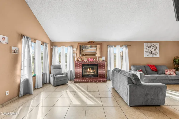 a dining room with furniture and a kitchen view