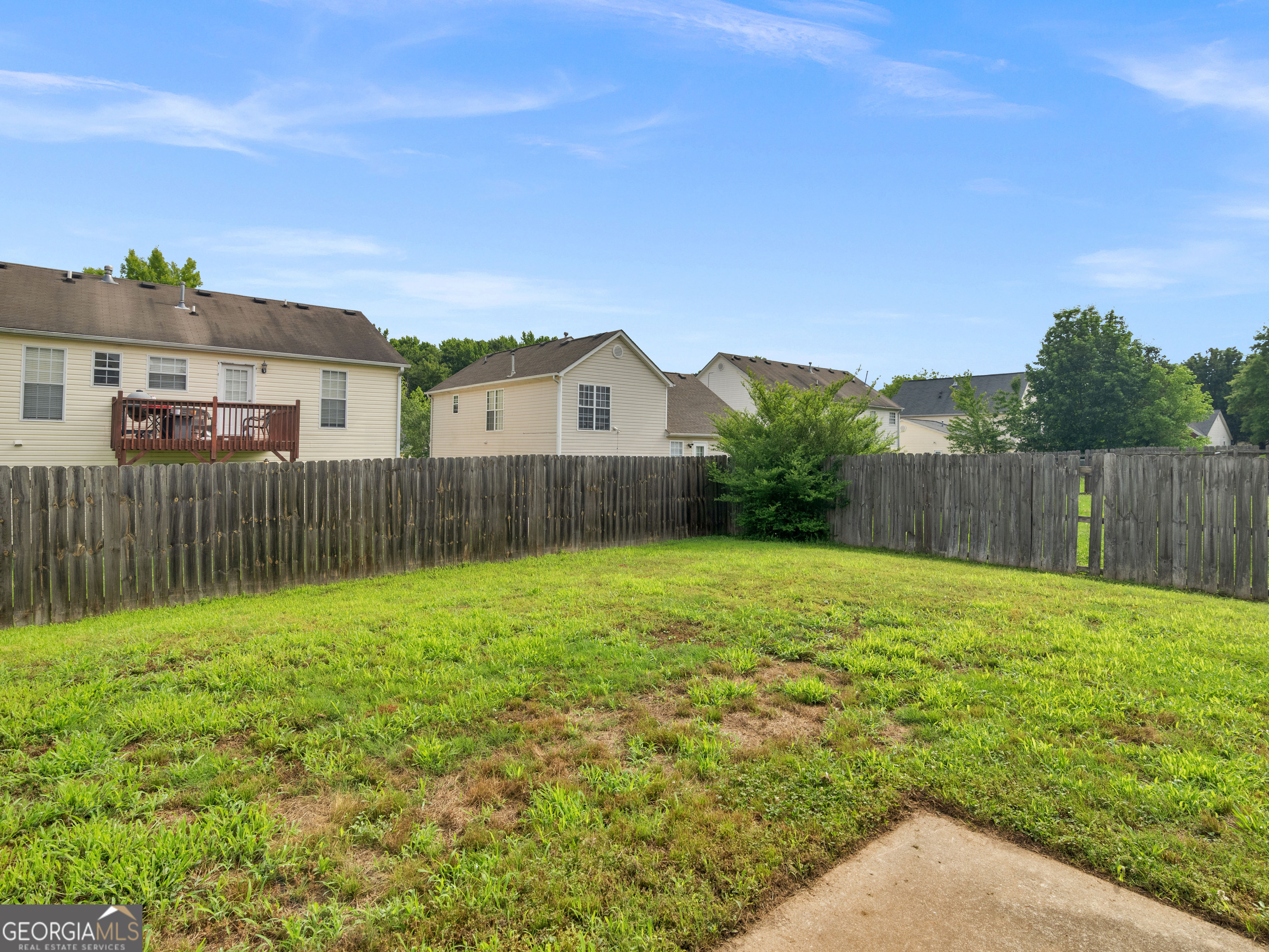 3370 Waggoner Place Rex, GA 30273 - Photo 24 of 25 a backyard of a house with plants and wooden fence