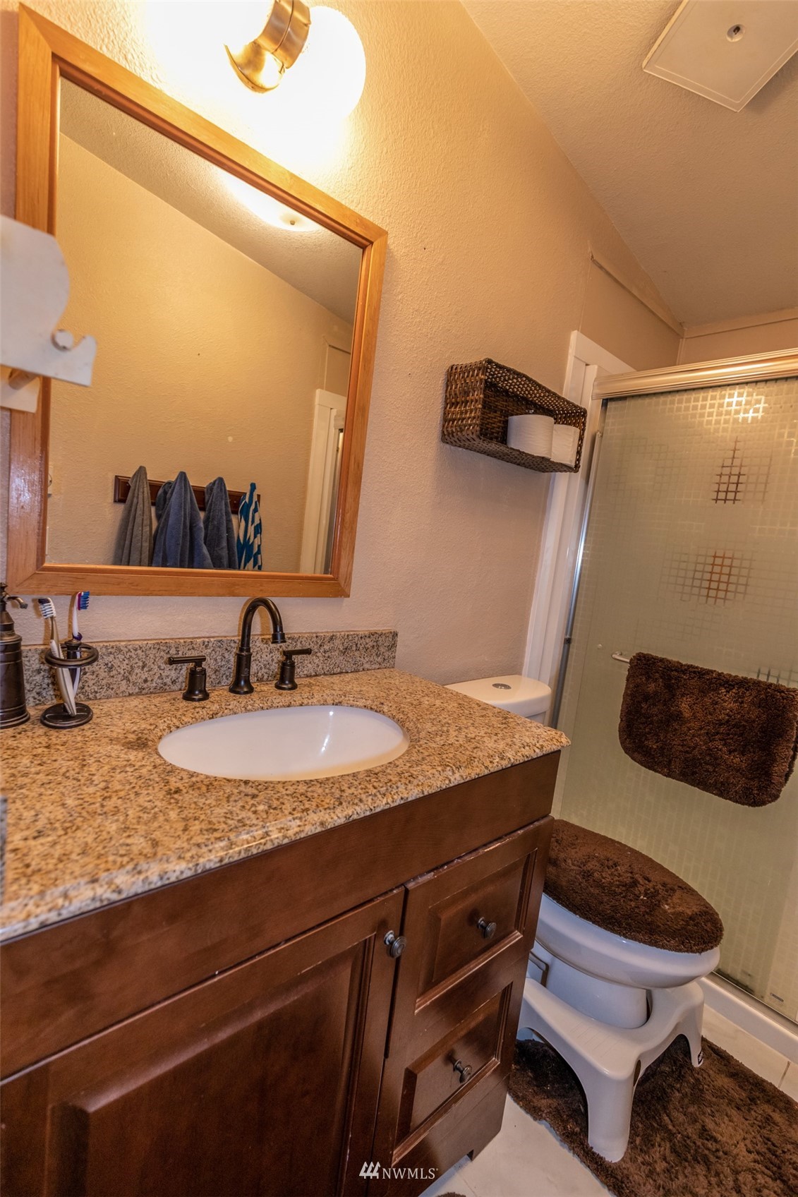 11205 180th Lane Southwest Rochester, WA 98579 - Photo 25 of 33 a bathroom with a granite countertop sink and a mirror