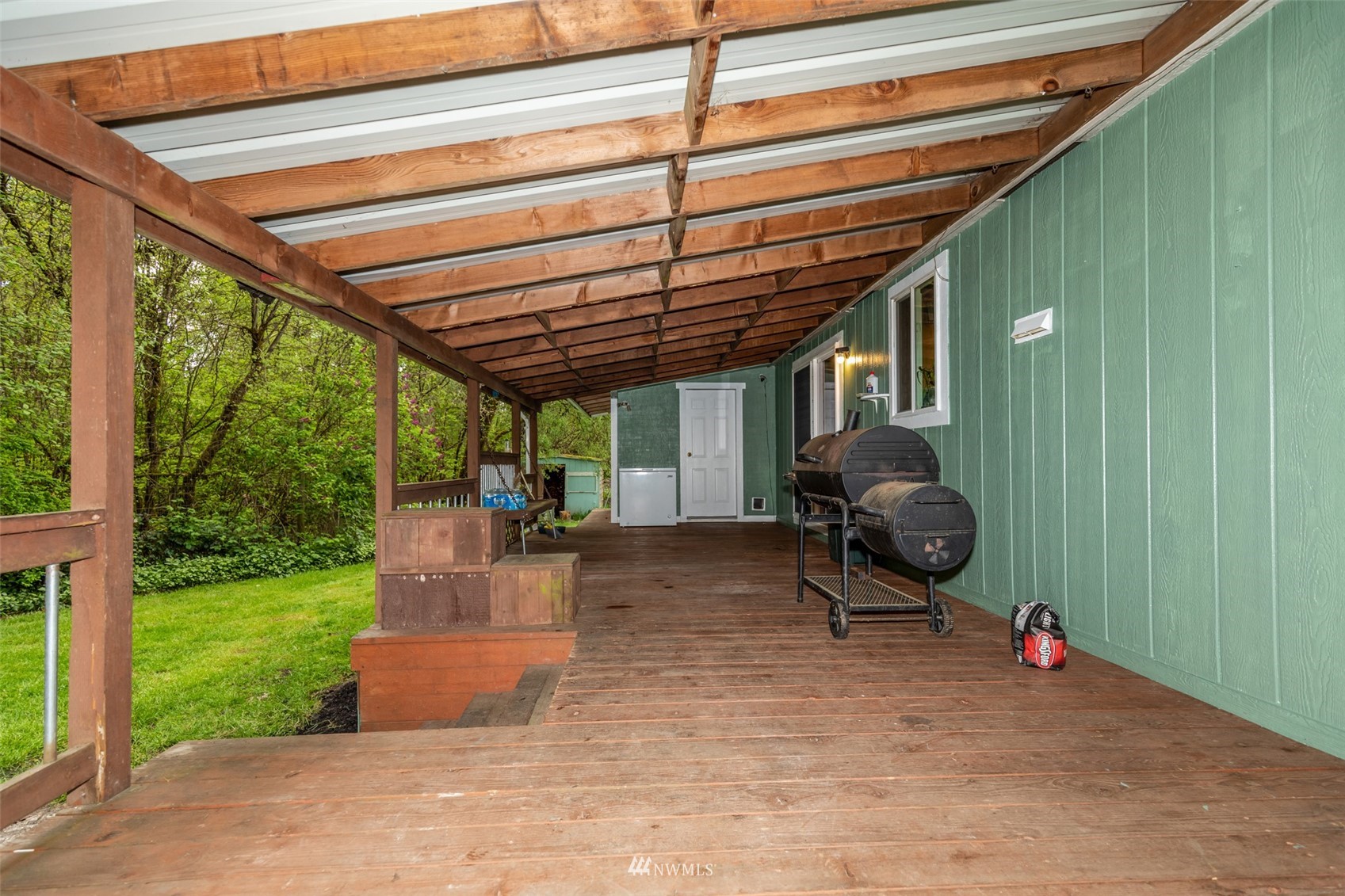 11205 180th Lane Southwest Rochester, WA 98579 - Photo 6 of 33 a view of a backyard with plants and a patio