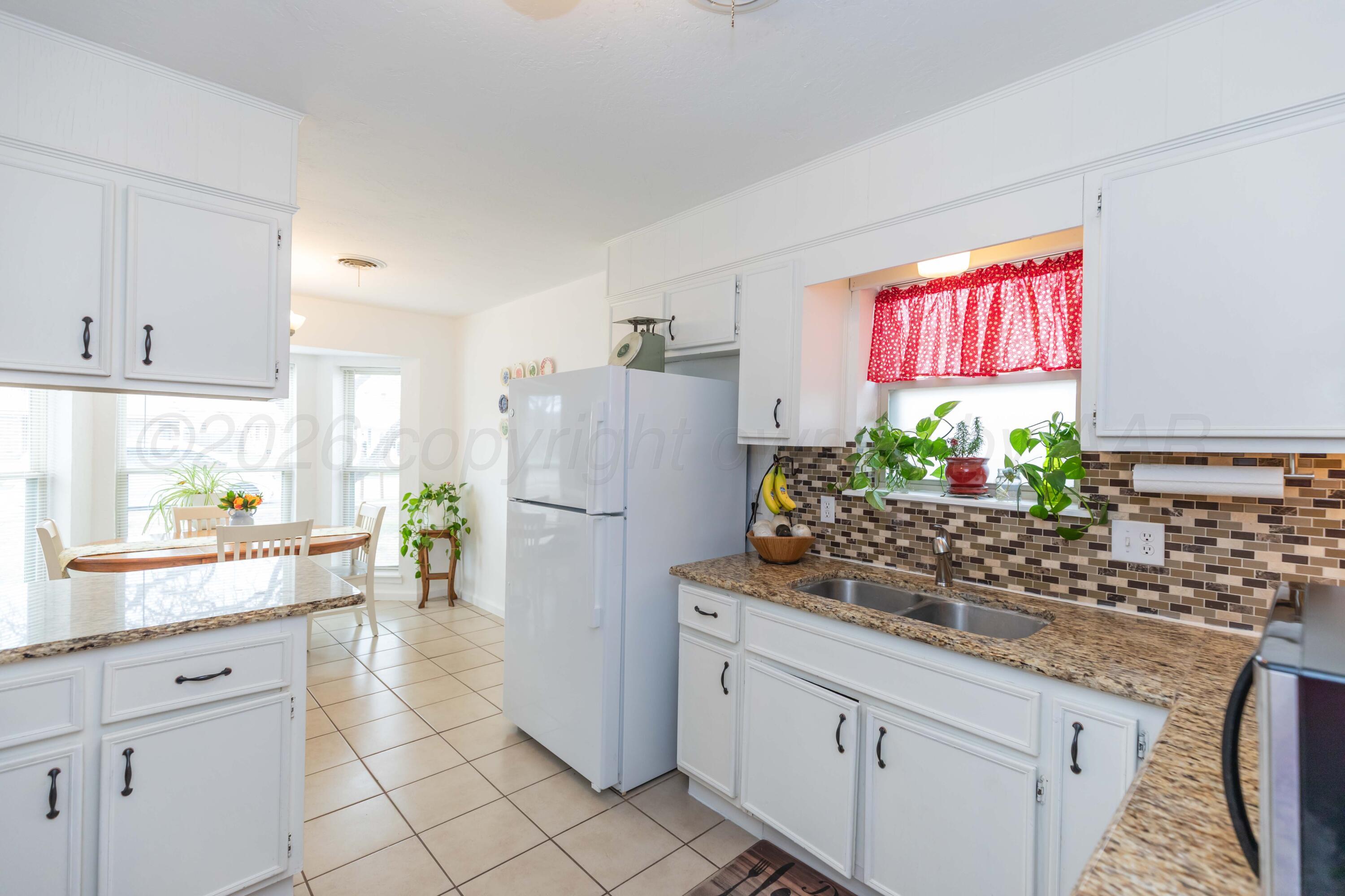 7308 Holyoke Trail Amarillo, TX 79121 - Photo 11 of 39 a kitchen with refrigerator and window