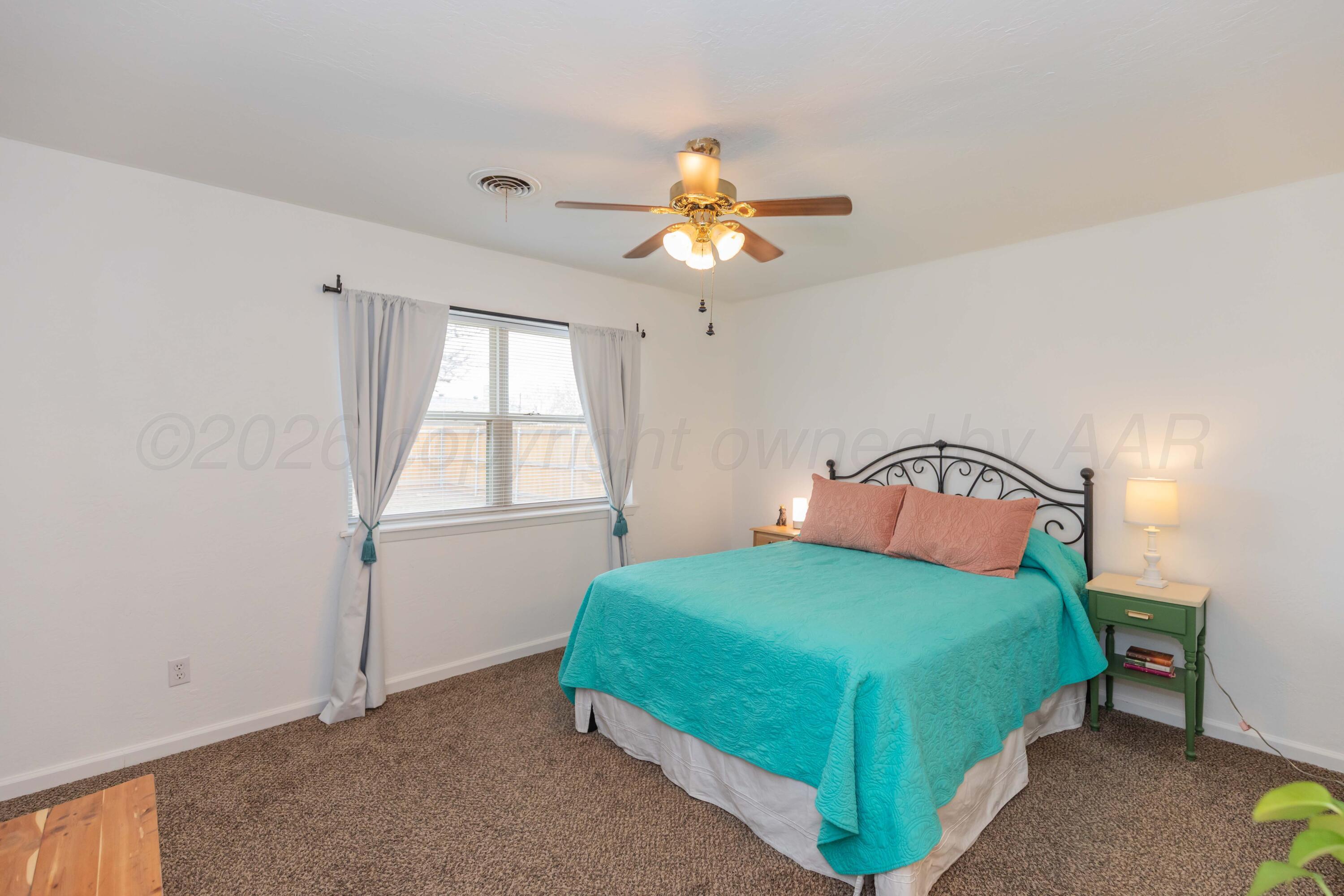 7308 Holyoke Trail Amarillo, TX 79121 - Photo 19 of 39 a bedroom with a bed and a window