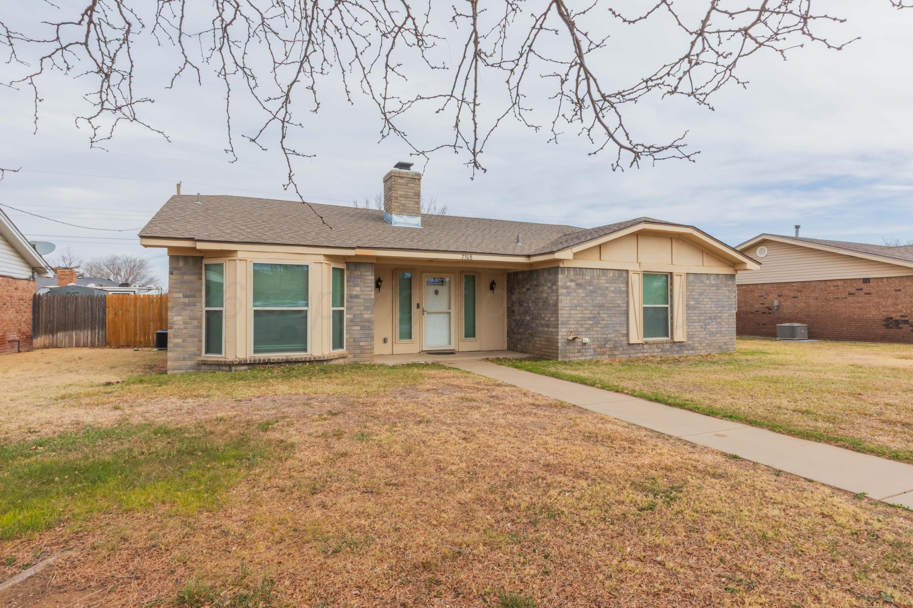 7308 Holyoke Trail Amarillo, TX 79121 - Photo 2 of 39 a front view of a house with a garden