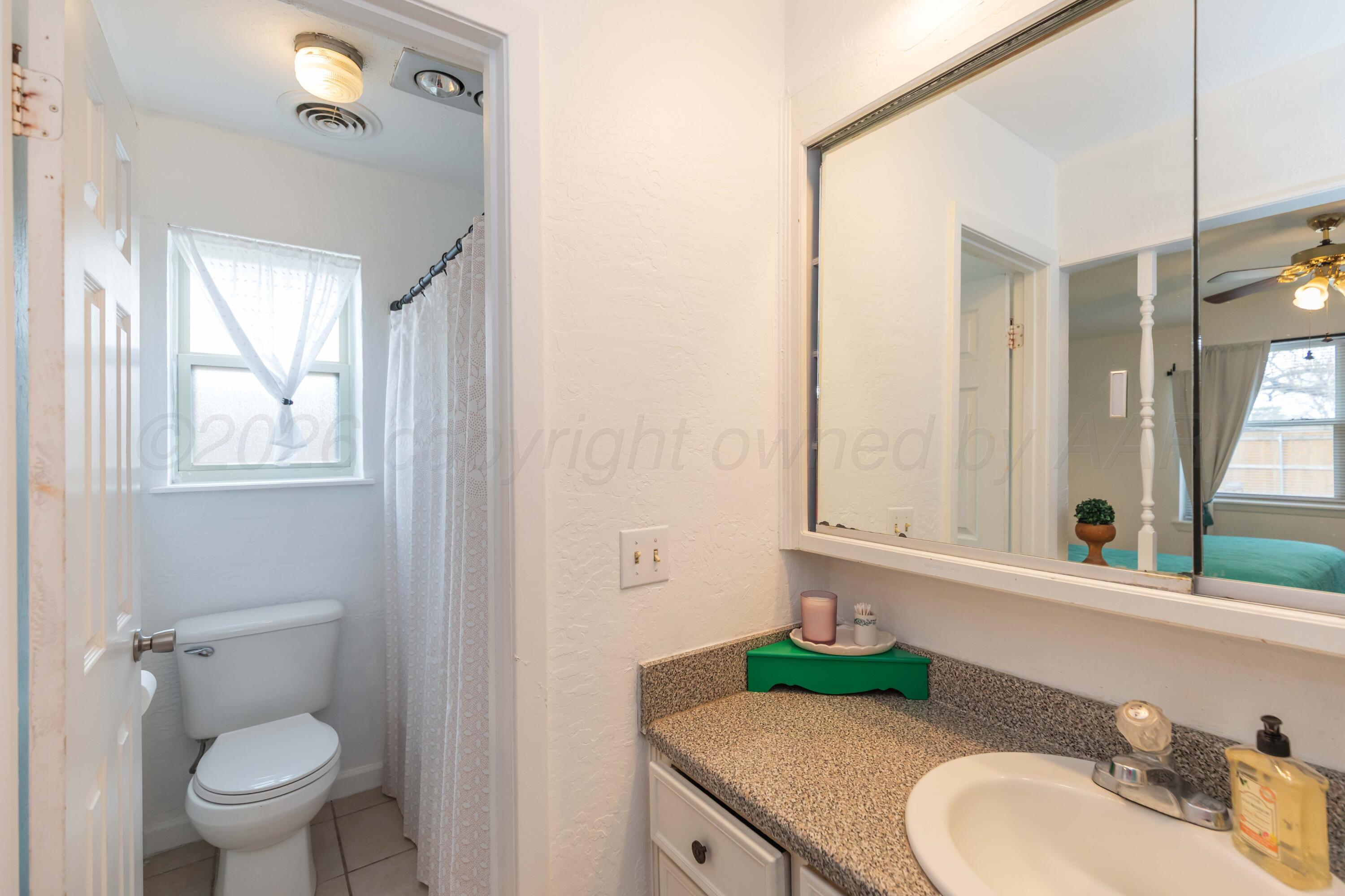 7308 Holyoke Trail Amarillo, TX 79121 - Photo 22 of 39 a bathroom with a granite countertop sink and a mirror