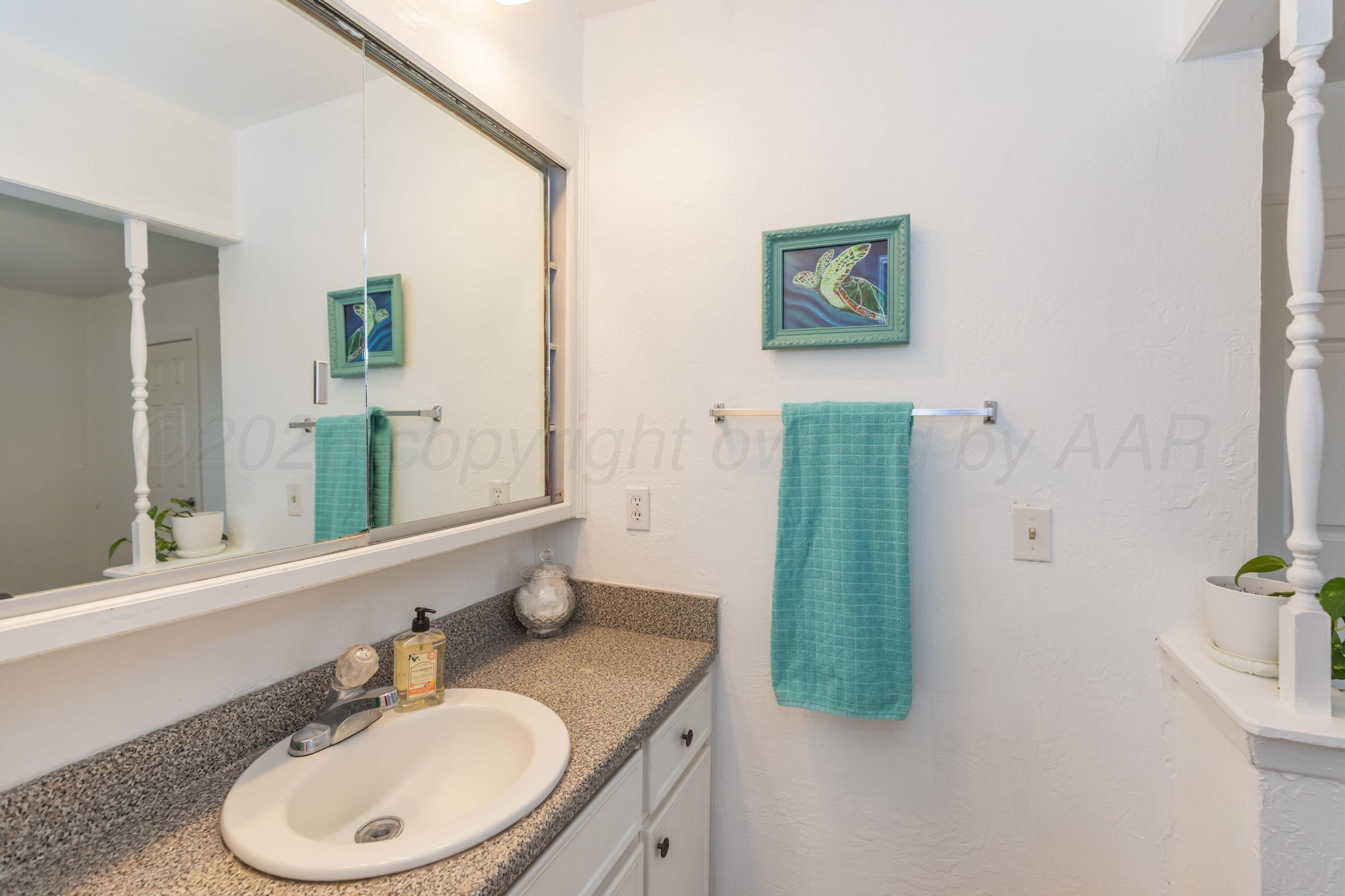 7308 Holyoke Trail Amarillo, TX 79121 - Photo 23 of 39 a bathroom with a granite countertop sink and a mirror