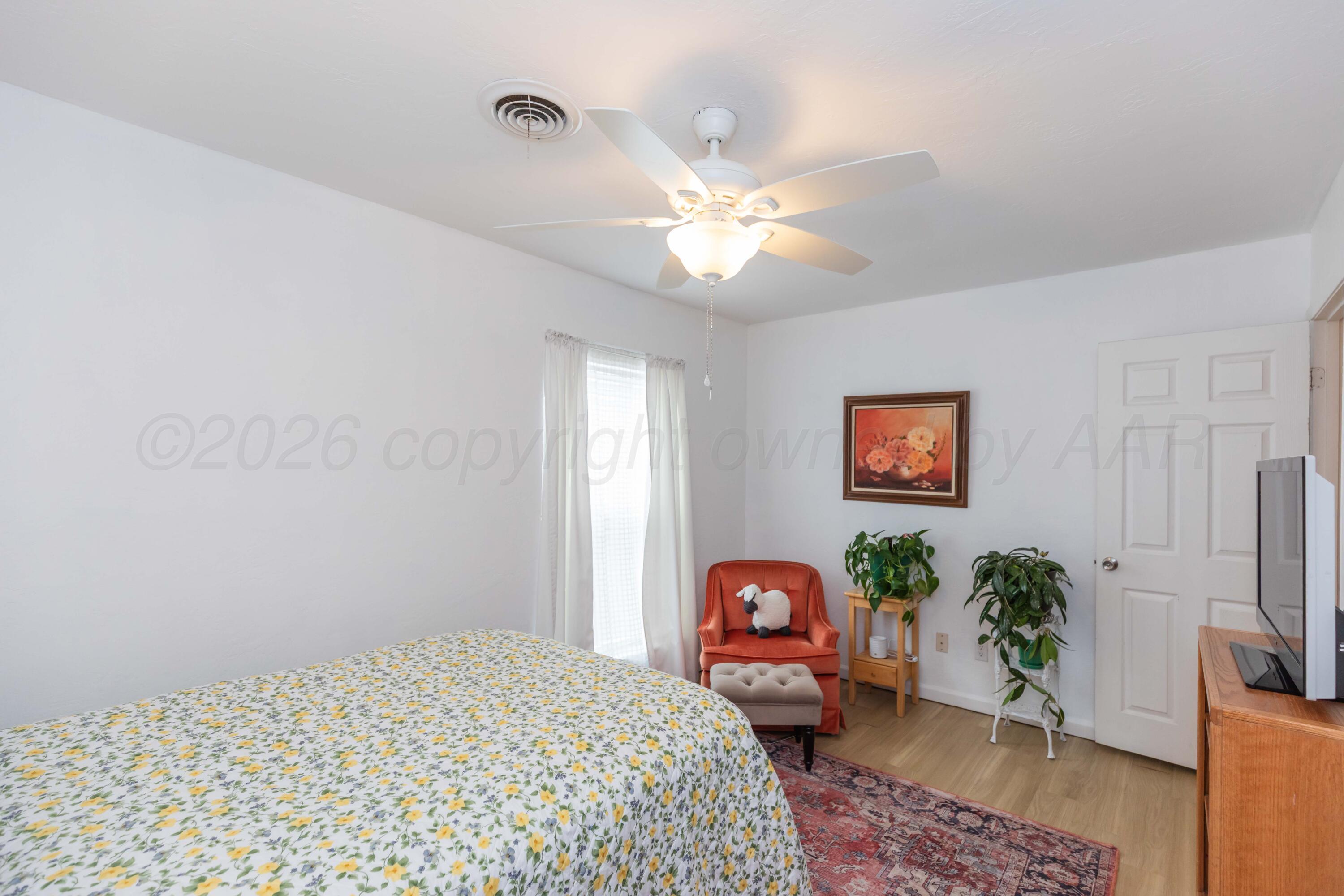 7308 Holyoke Trail Amarillo, TX 79121 - Photo 25 of 39 a bedroom with a bed dresser and a window