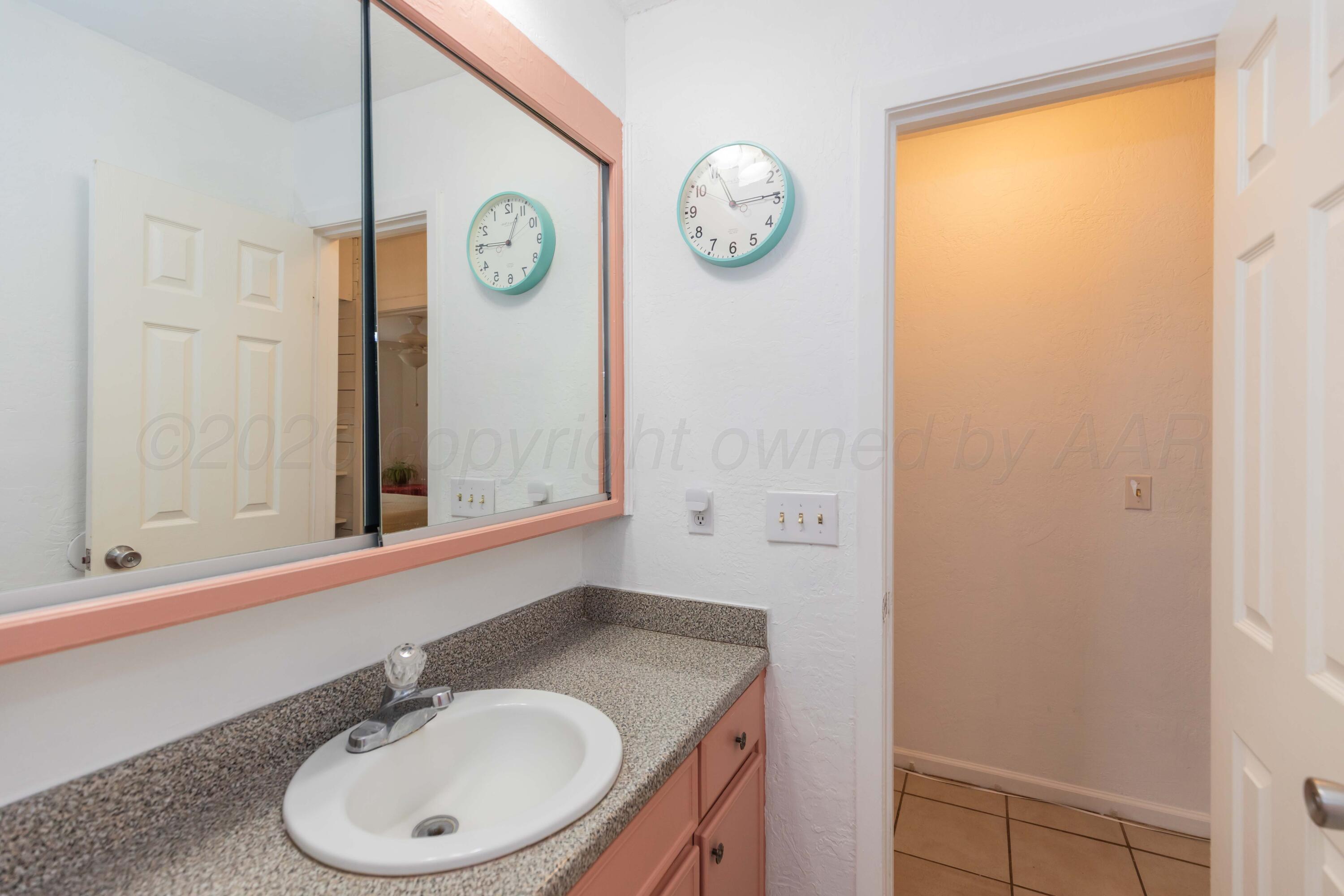 7308 Holyoke Trail Amarillo, TX 79121 - Photo 26 of 39 a bathroom with a sink and a mirror