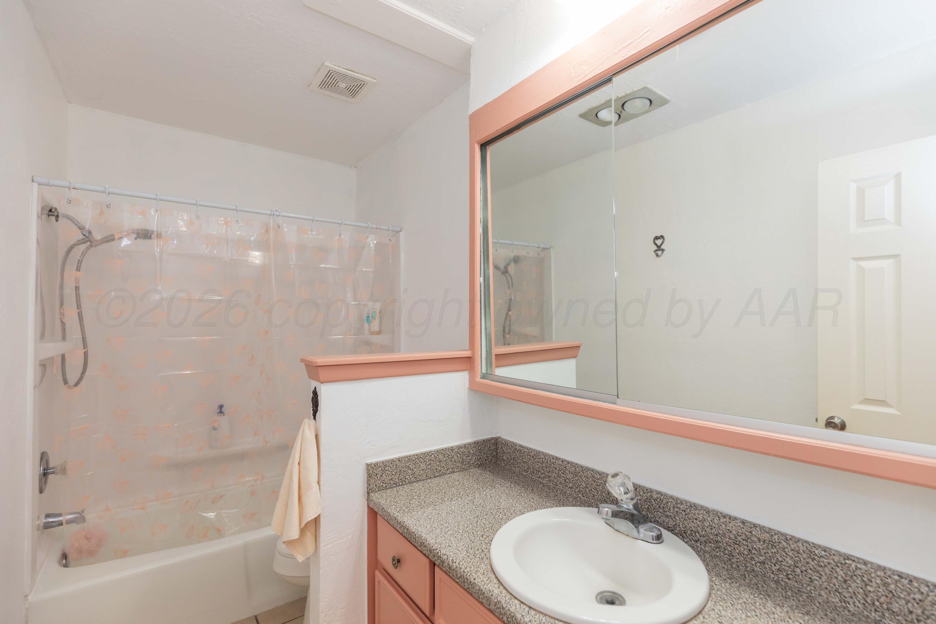 7308 Holyoke Trail Amarillo, TX 79121 - Photo 27 of 39 a bathroom with a granite countertop sink toilet and shower