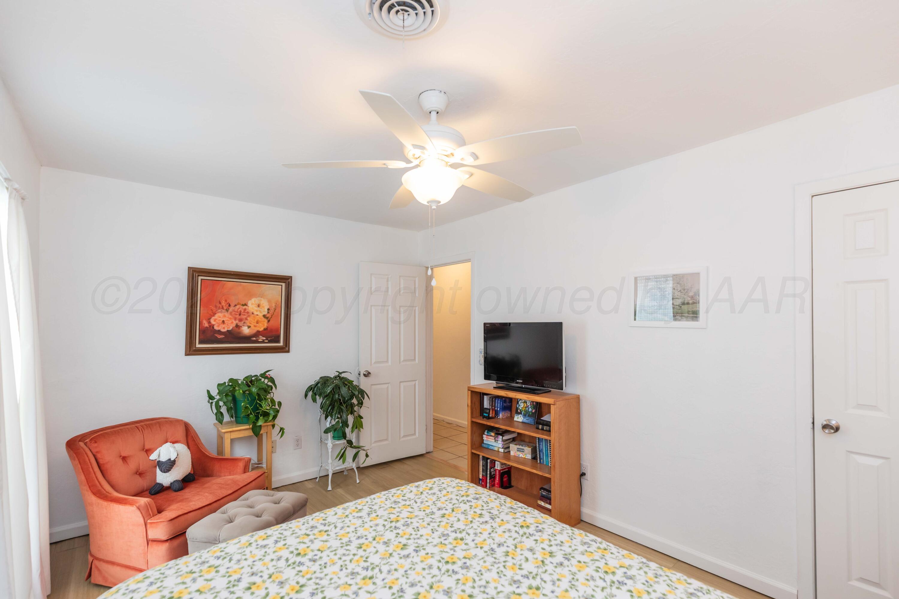 7308 Holyoke Trail Amarillo, TX 79121 - Photo 28 of 39 a bedroom with furniture and a flat screen tv