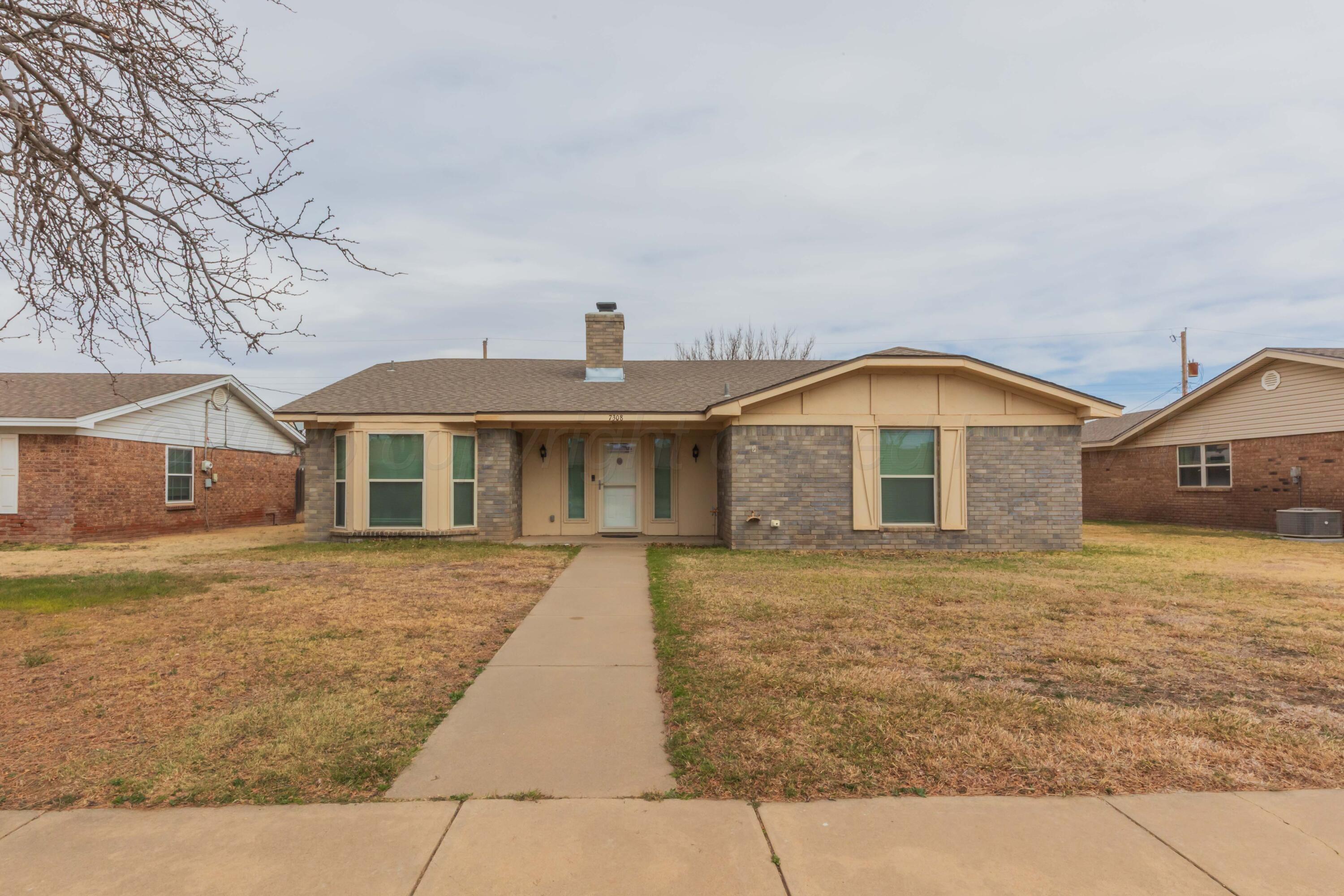 7308 Holyoke Trail Amarillo, TX 79121 - Photo 3 of 39 a front view of a house with a yard and garage
