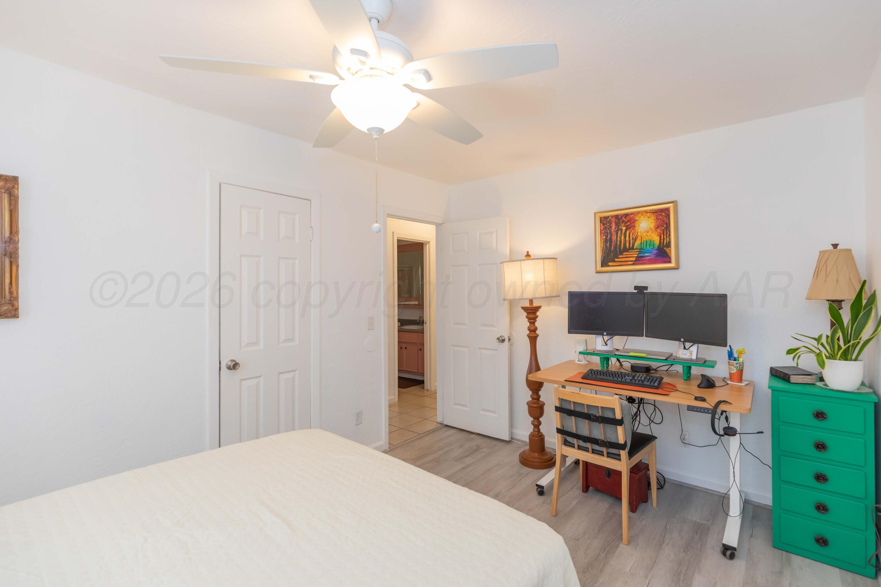 7308 Holyoke Trail Amarillo, TX 79121 - Photo 32 of 39 a bedroom with a bed and a workspace
