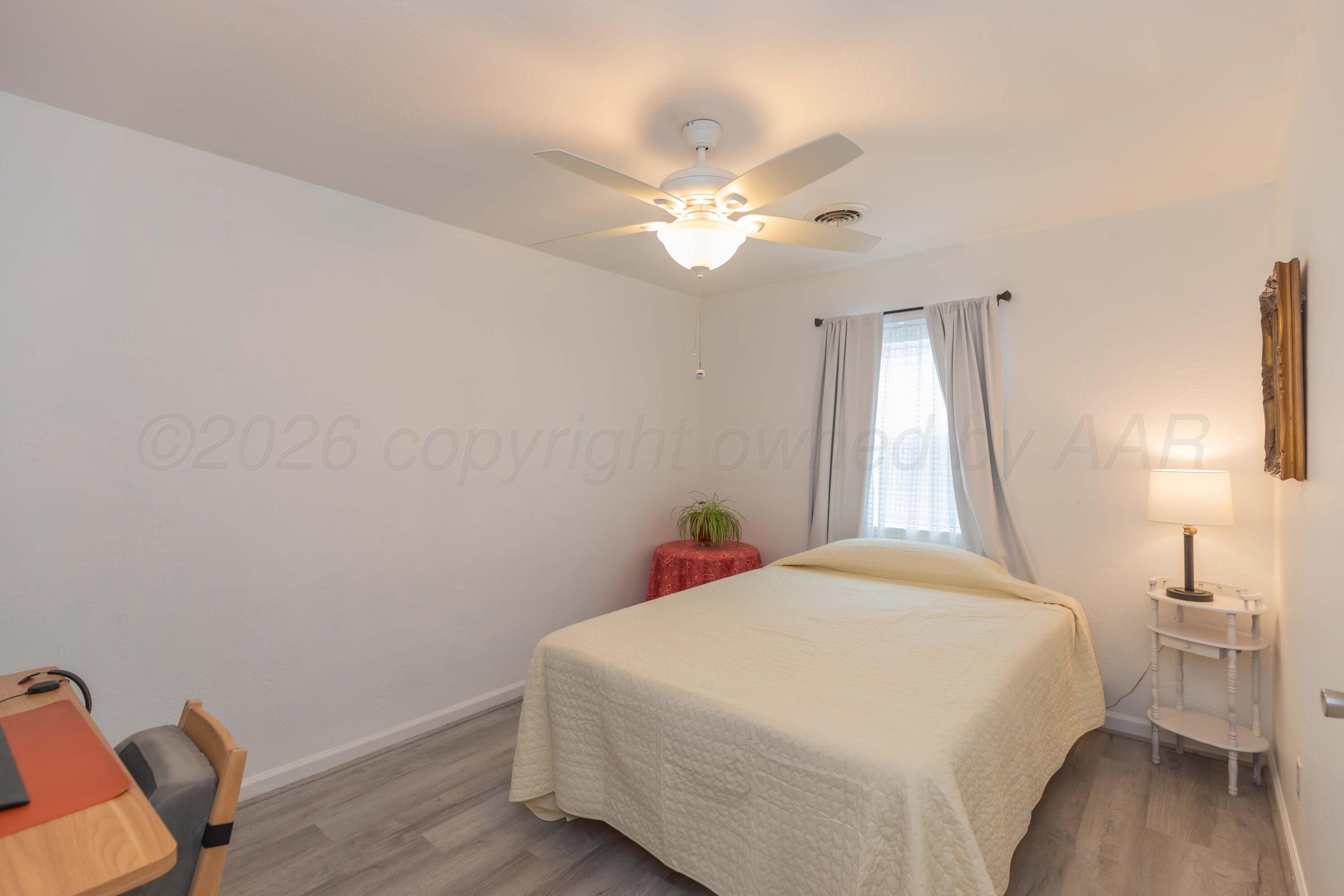 7308 Holyoke Trail Amarillo, TX 79121 - Photo 33 of 39 a bedroom with a bed and a chandelier