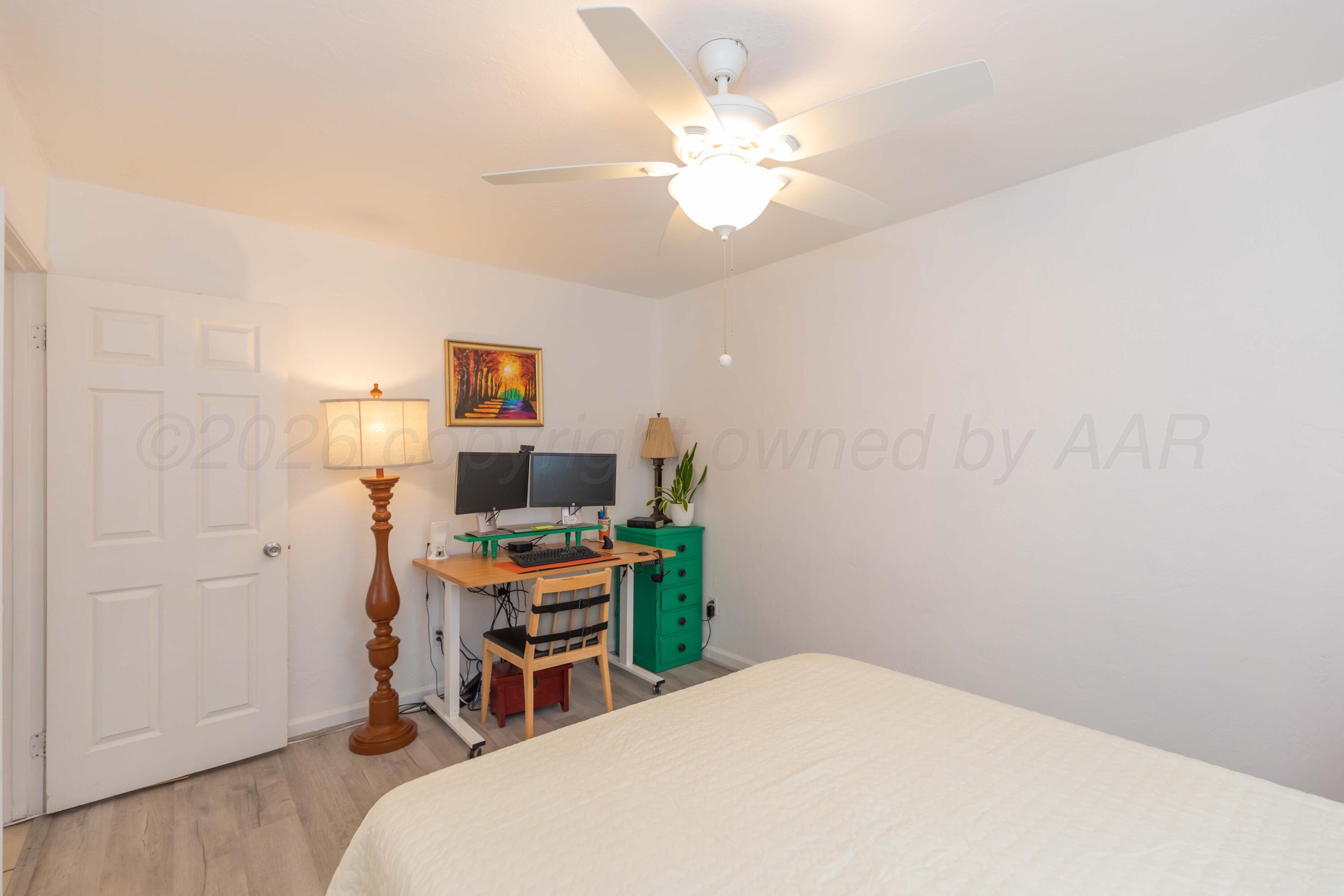 7308 Holyoke Trail Amarillo, TX 79121 - Photo 34 of 39 a bedroom with a bed and a chandelier