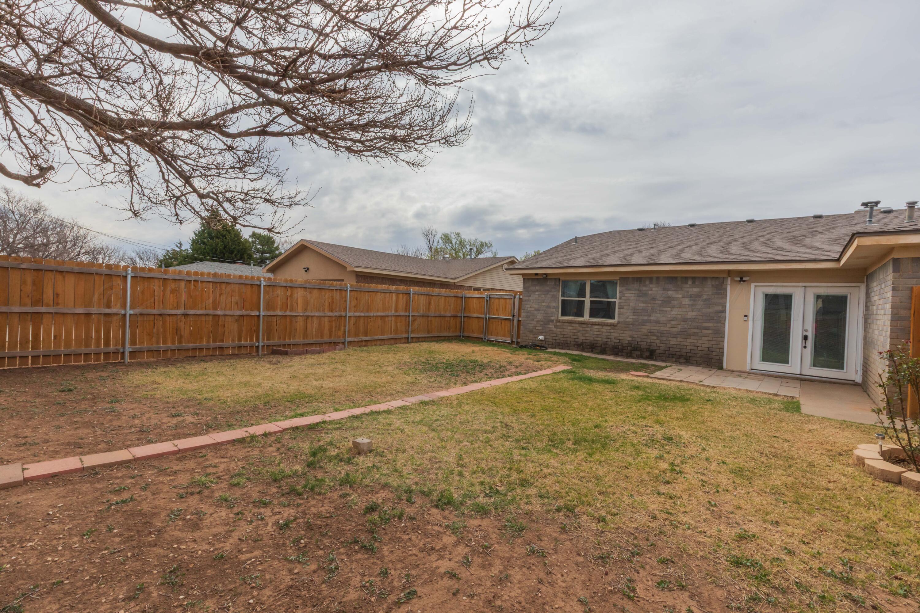 7308 Holyoke Trail Amarillo, TX 79121 - Photo 37 of 39 a view of a house with backyard and trees