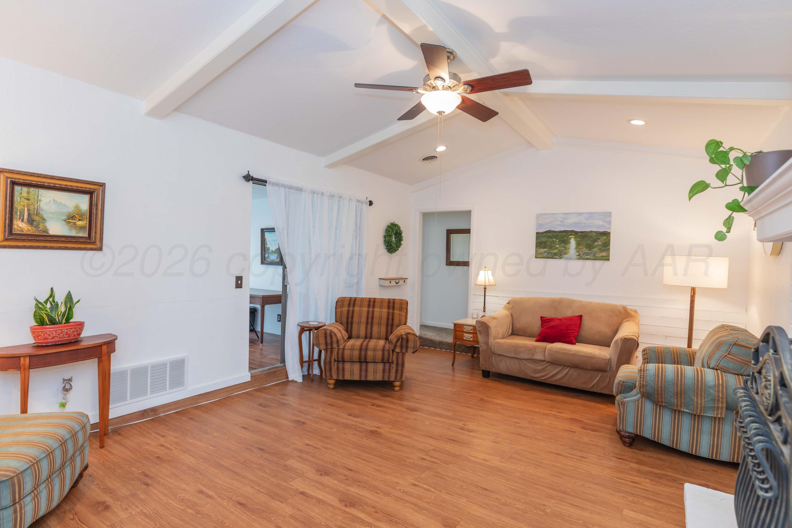 7308 Holyoke Trail Amarillo, TX 79121 - Photo 7 of 39 a living room with furniture and a wooden floor