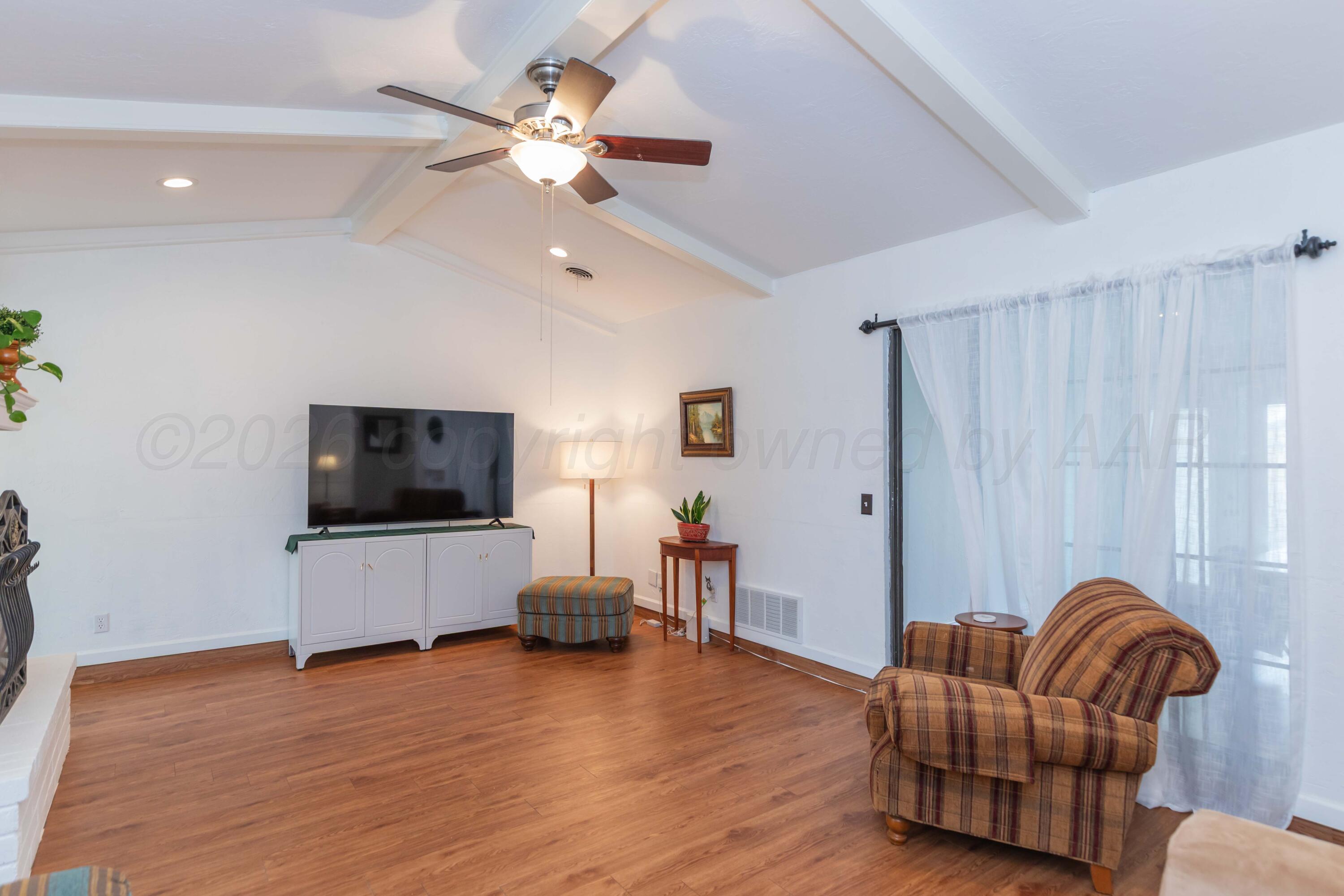7308 Holyoke Trail Amarillo, TX 79121 - Photo 10 of 39 a living room with furniture and a flat screen tv