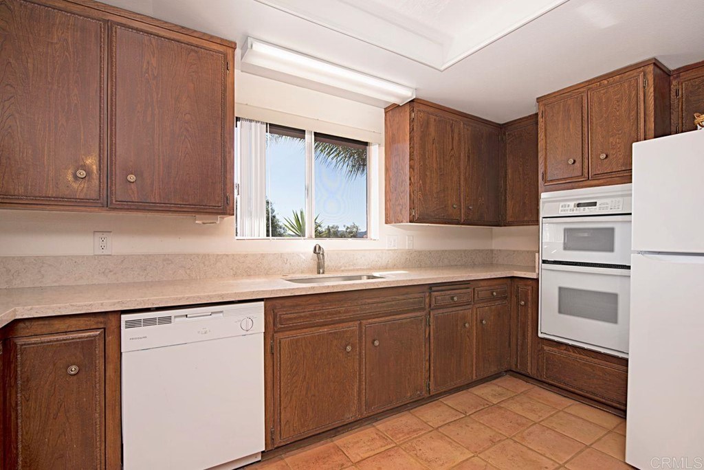 29573 Miller Road Valley Center, CA 92082 - Photo 12 of 37 a kitchen with a sink and cabinets