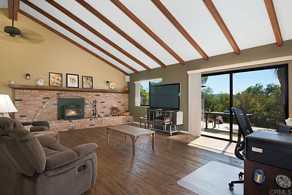 29573 Miller Road Valley Center, CA 92082 - Photo 15 of 37 a living room with furniture a flat screen tv and a floor to ceiling window