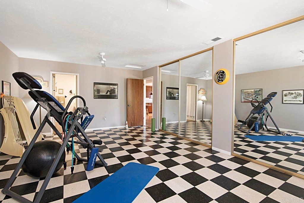 29573 Miller Road Valley Center, CA 92082 - Photo 23 of 37 a room with gym equipment and glass door