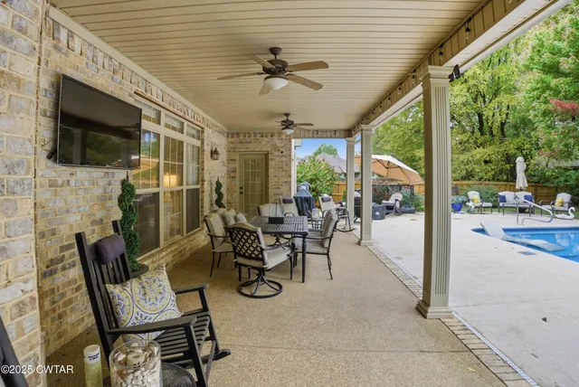 a living room with furniture a fireplace and a floor to ceiling window