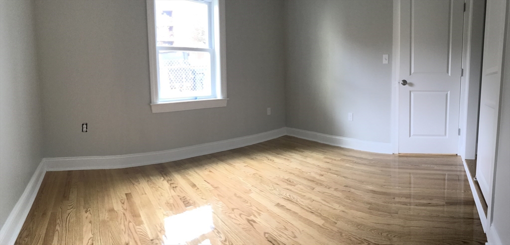 6 St James Place, Unit 6 Boston, MA 02119 - Photo 11 of 18 a view of empty room with wooden floor and fan