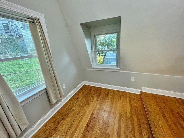 6 St James Place, Unit 6 Boston, MA 02119 - Photo 15 of 18 a view of an empty room with wooden floor and a window