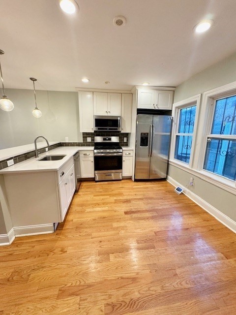 6 St James Place, Unit 6 Boston, MA 02119 - Photo 2 of 18 a large kitchen with stainless steel appliances granite countertop a refrigerator and a stove top oven