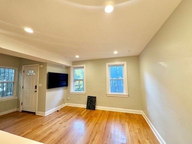 6 St James Place, Unit 6 Boston, MA 02119 - Photo 3 of 18 a view of empty room with wooden floor and windows