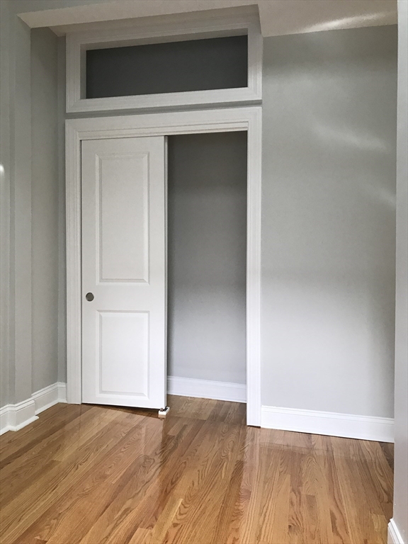 6 St James Place, Unit 6 Boston, MA 02119 - Photo 5 of 18 a view of a livingroom with wooden floor