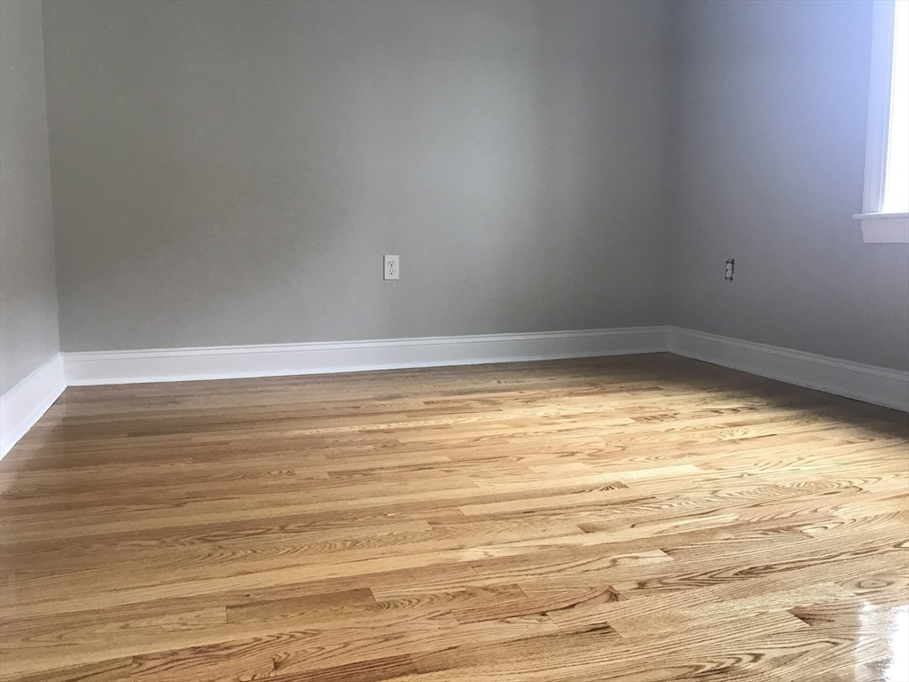 6 St James Place, Unit 6 Boston, MA 02119 - Photo 8 of 18 a view of empty room with wooden floor