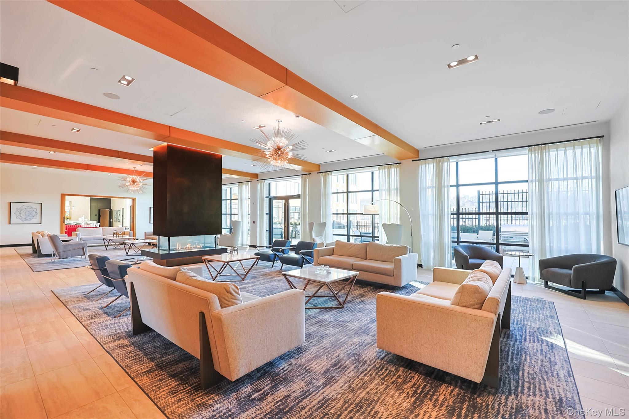 100 Garvies Point Road, Unit 1024 Glen Cove, NY 11542 - Photo 11 of 41 a living room with furniture fireplace and a large window