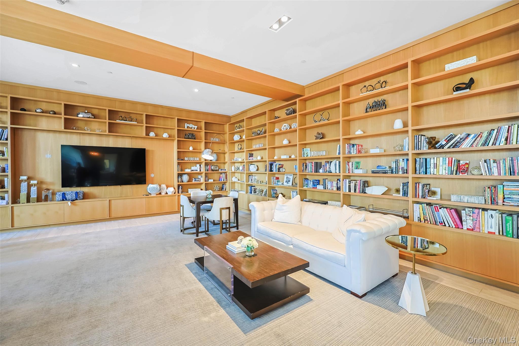 100 Garvies Point Road, Unit 1024 Glen Cove, NY 11542 - Photo 12 of 41 a living room with fireplace furniture and a flat screen tv