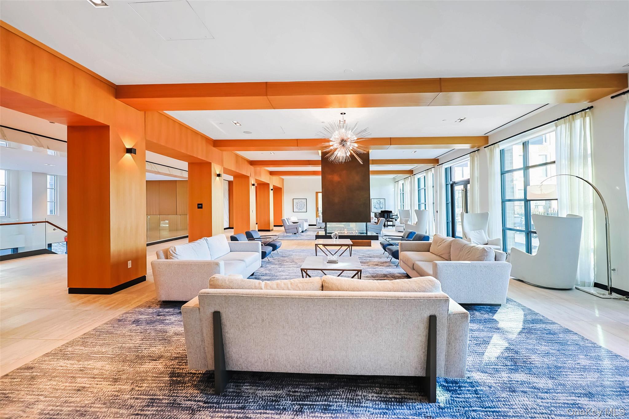 100 Garvies Point Road, Unit 1024 Glen Cove, NY 11542 - Photo 13 of 41 a living room with fireplace furniture and a large window