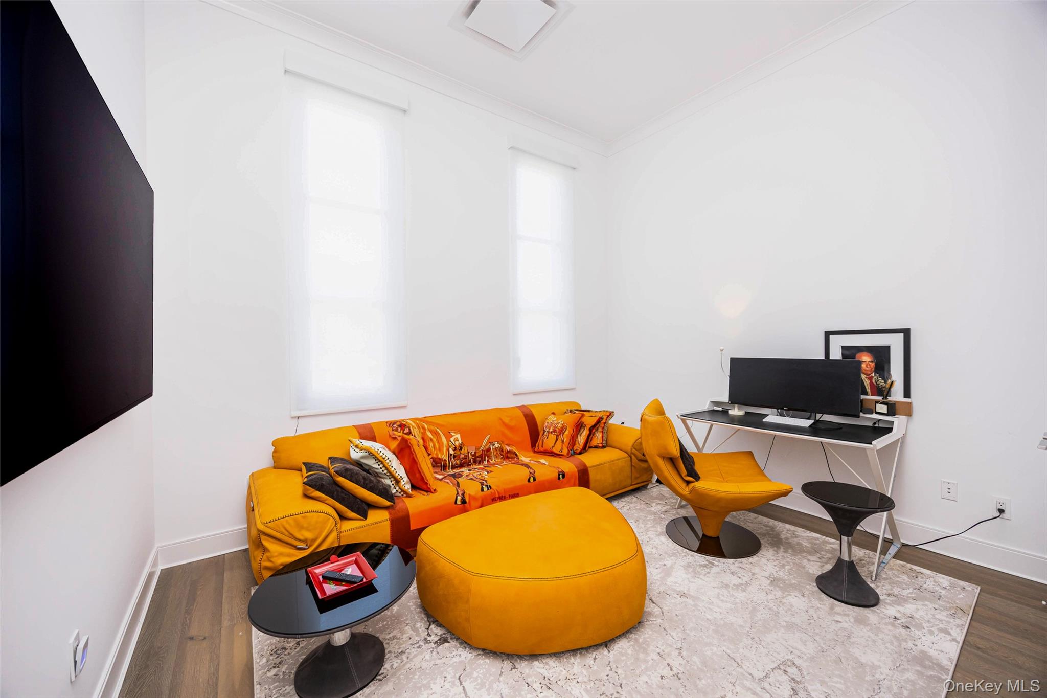 100 Garvies Point Road, Unit 1024 Glen Cove, NY 11542 - Photo 16 of 41 a living room with furniture and a flat screen tv