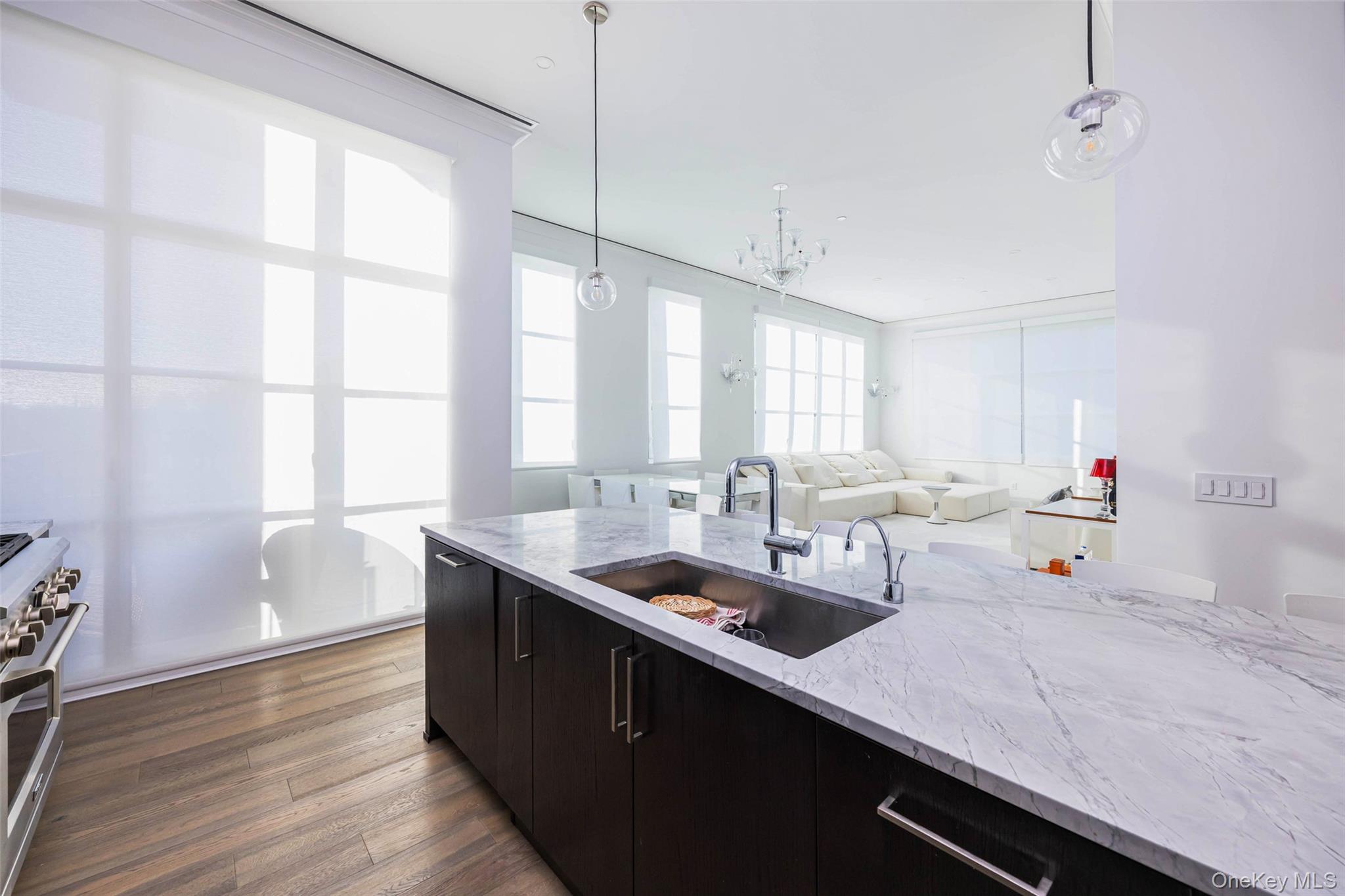100 Garvies Point Road, Unit 1024 Glen Cove, NY 11542 - Photo 20 of 41 a kitchen with sink cabinets and wooden floor