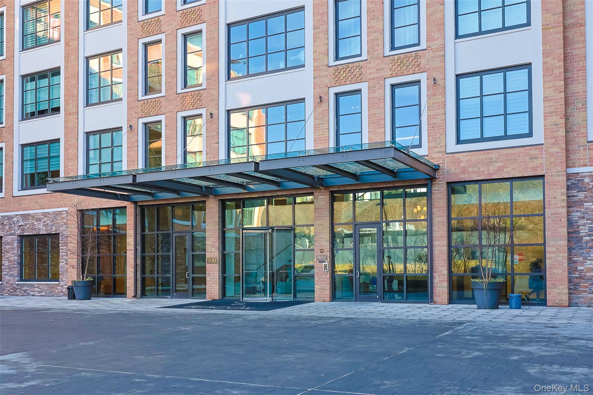 100 Garvies Point Road, Unit 1024 Glen Cove, NY 11542 - Photo 2 of 41 a front view of a brick building with a large windows